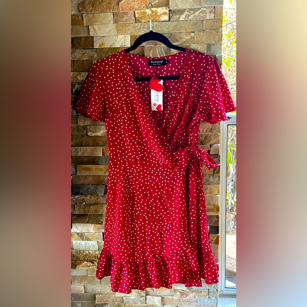Red side tie mini dress with white polkadots and capped sleeves, size small.